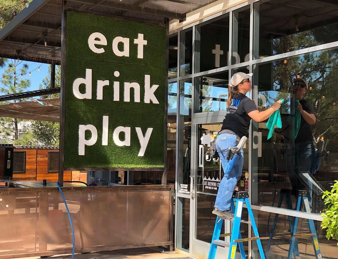 Clearvu technician cleaning restaurant storefront windows in Temecula