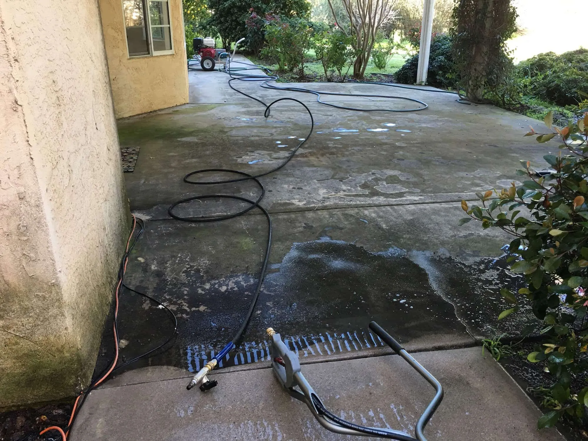 Dirty concrete driveway before professional pressure washing