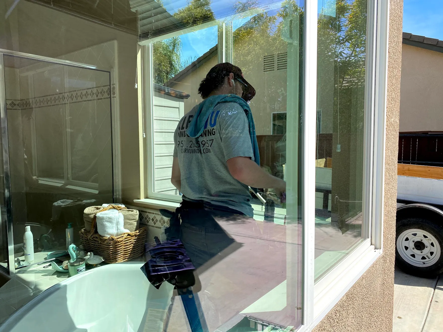 Clearvu technician hand-cleaning interior window glass in a Temecula home